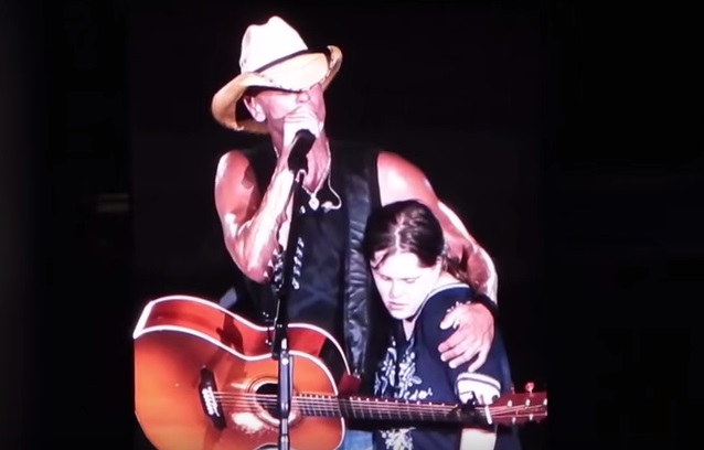 Kenny Chesney Gives Fan A Memorable On-Stage Kiss