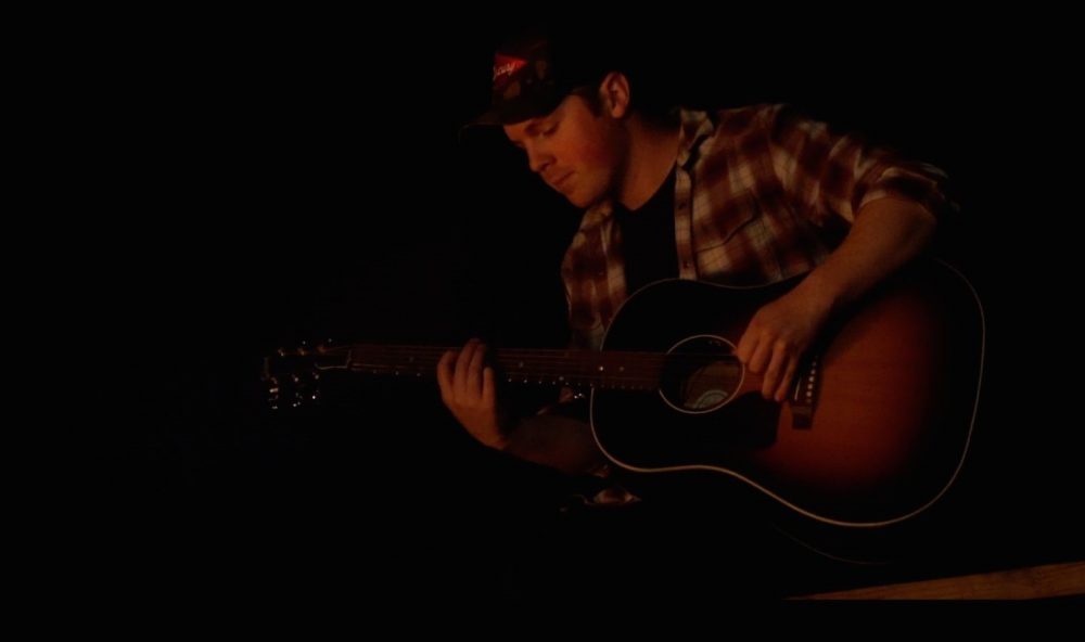 Travis Denning Stays Safe in Love With ‘Sittin By a Fire’ Video